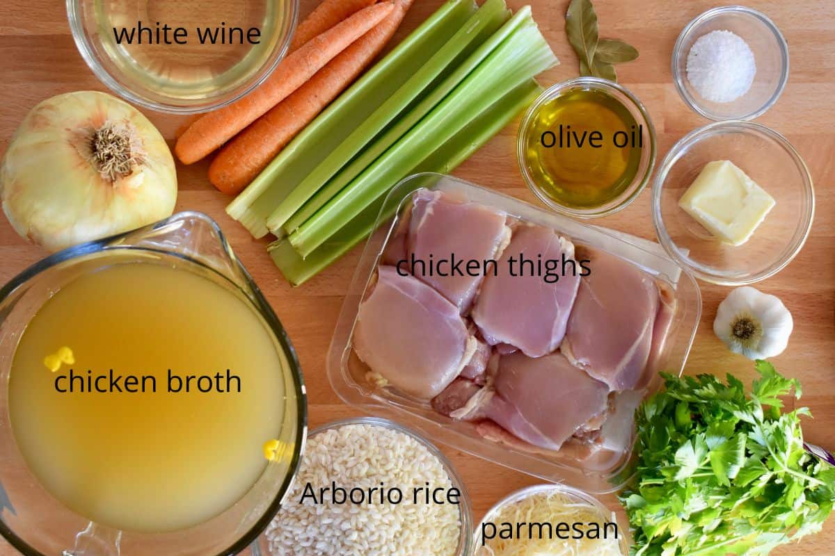 overhead photo of ingredients for recipe including broth, celery, red wine, and arborio rice. 