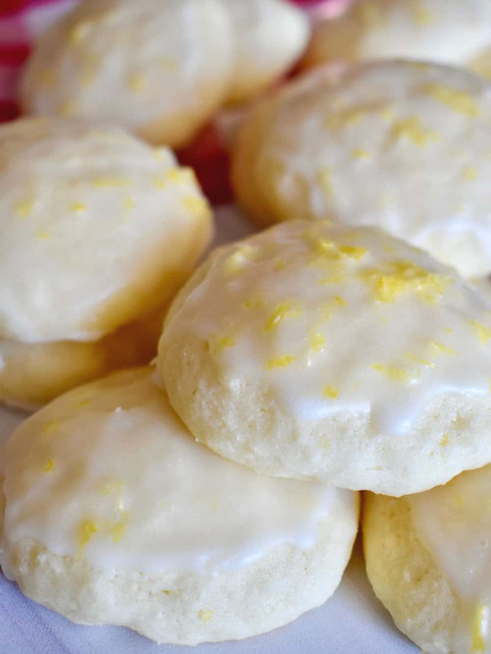 Lemon Ricotta Cookies on a white counter top stacked on each other. 