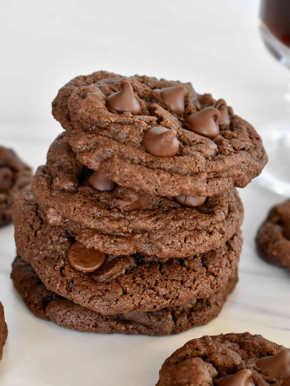 Chocolate Espresso Cookies stacked on each other on a white countertop. 