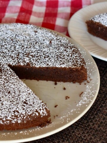 torta caprese is a delicious Italian flourless chocolate cake on a checkered napkin.