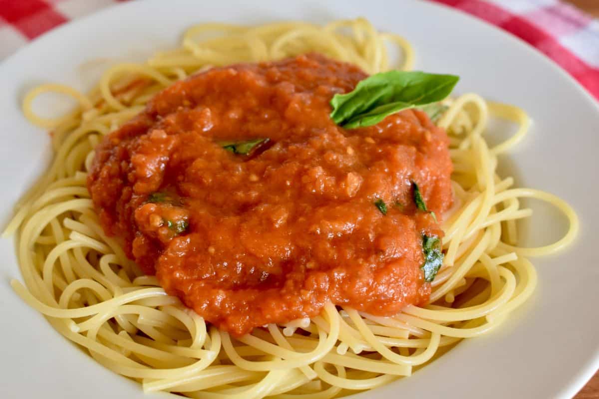 Sugo di pomodoro on spaghetti in a white bowl. 