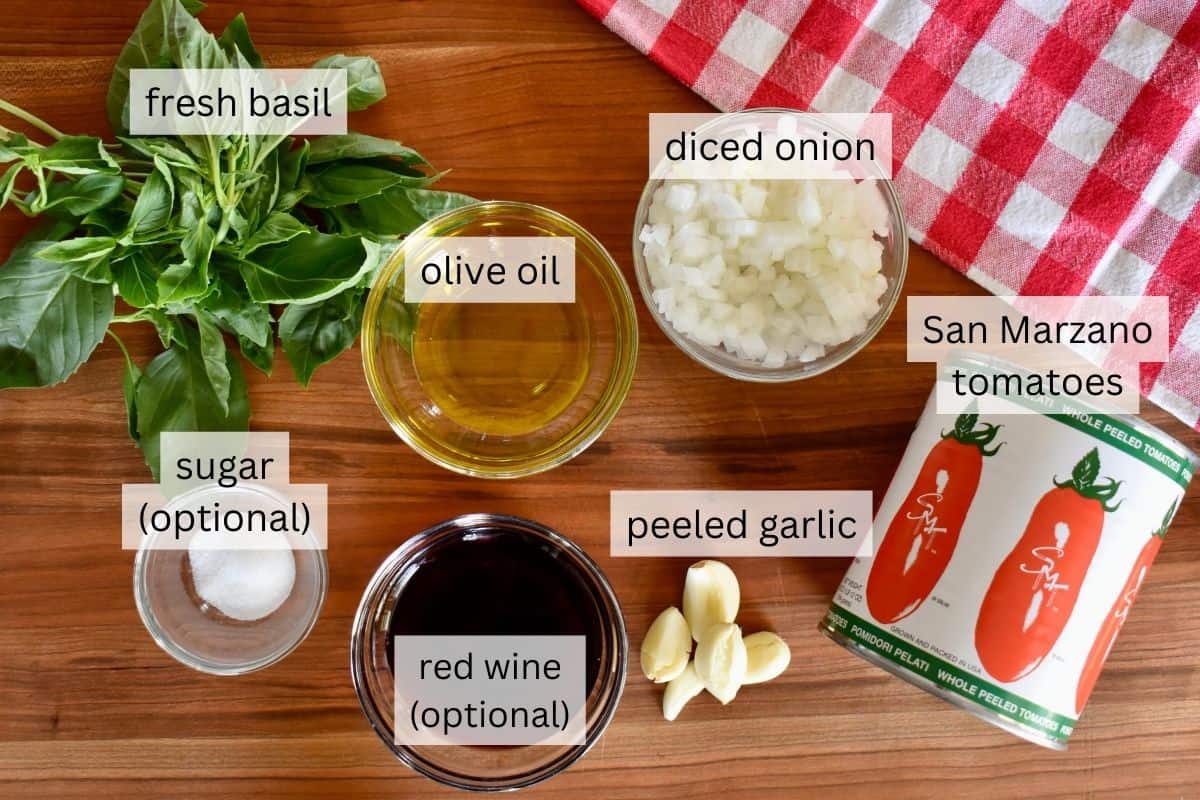 ingredients needed to make sauce including San Marzano tomatoes, onions, basil, and olive oil. 
