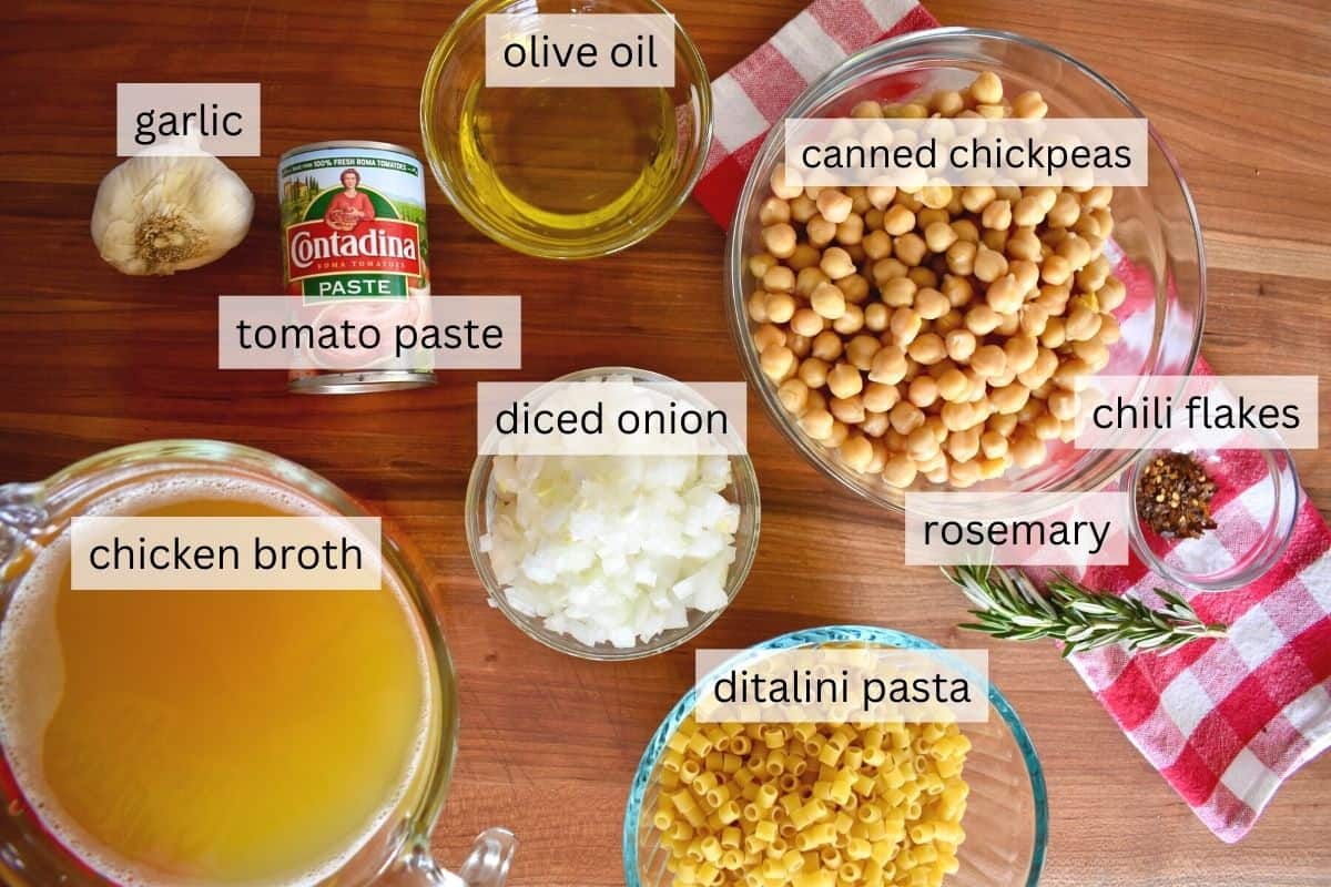 overhead photo of ingredients including chickpeas, ditalini, onions, broth, rosemary, garlic, and red pepper flakes. 