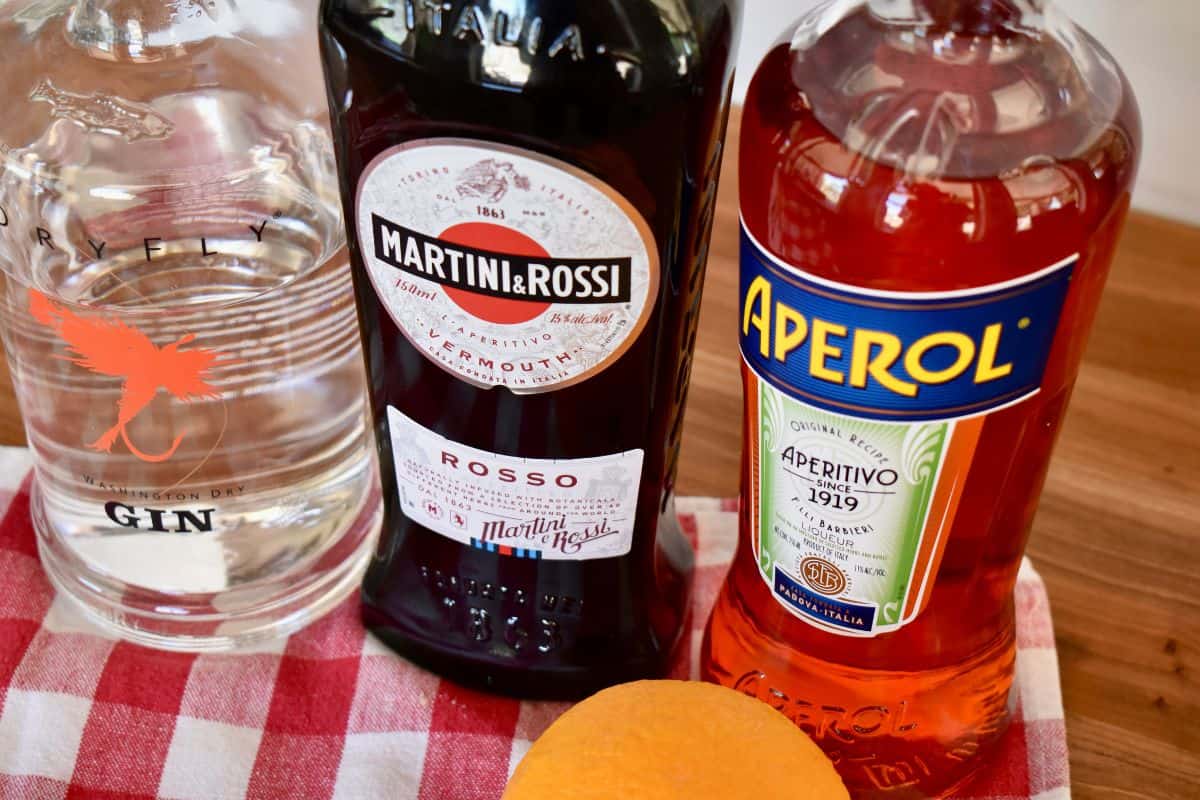 ingredients needed for recipe including gin, sweet vermouth, and Italian bitters. 