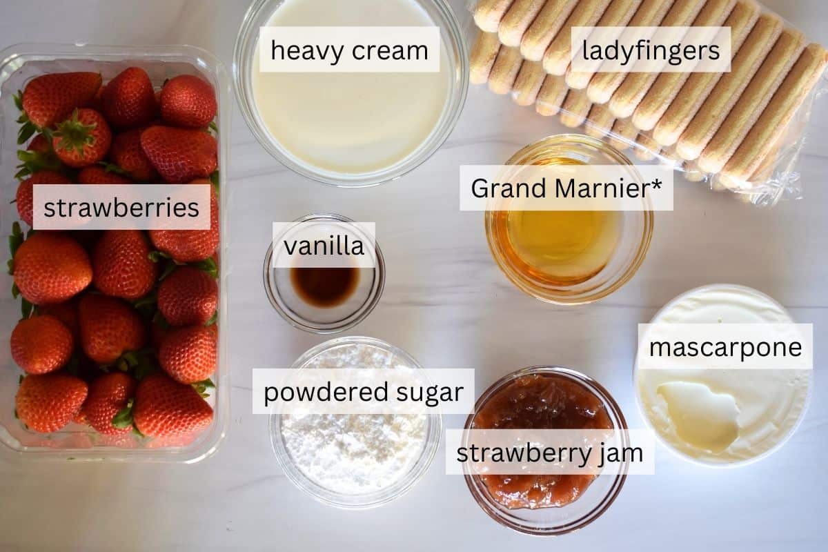 overhead photo of ingredients including ladyfingers, mascarpone, heavy cream, powdered sugar, and Grand Marnier. 