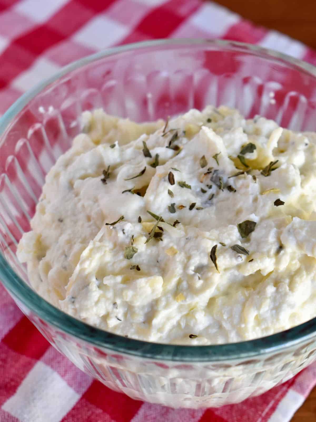 Ricotta filling recipe in a glass bowl on a checkered napkin. 