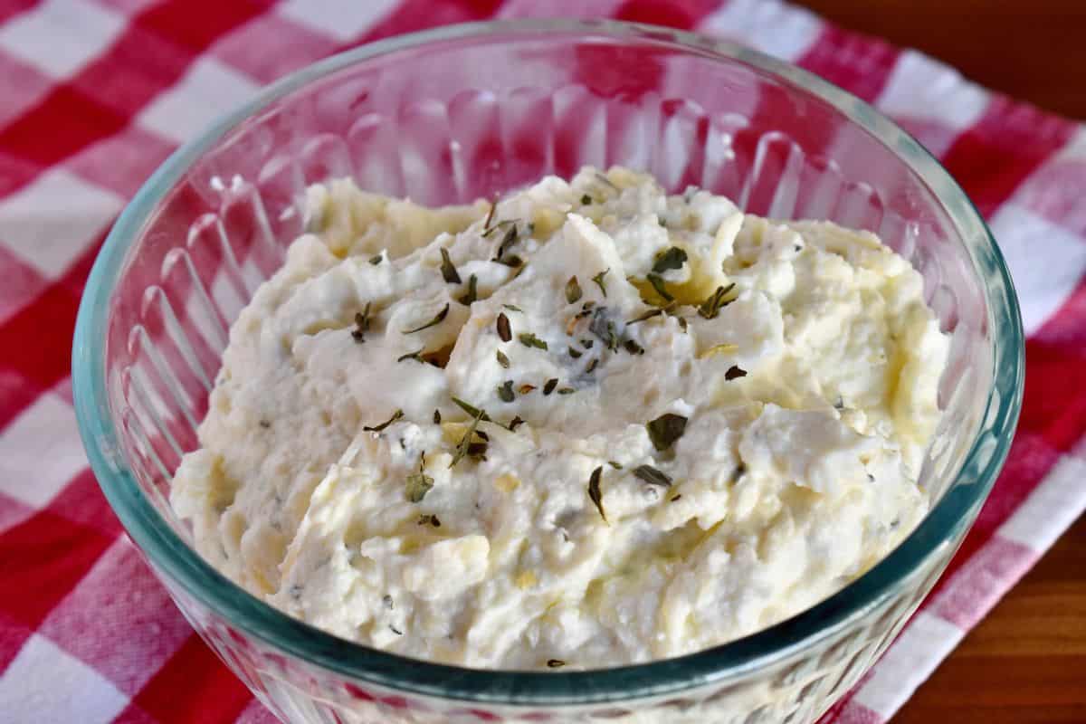 Ricotta filling recipe in a glass bowl on a checkered napkin. 