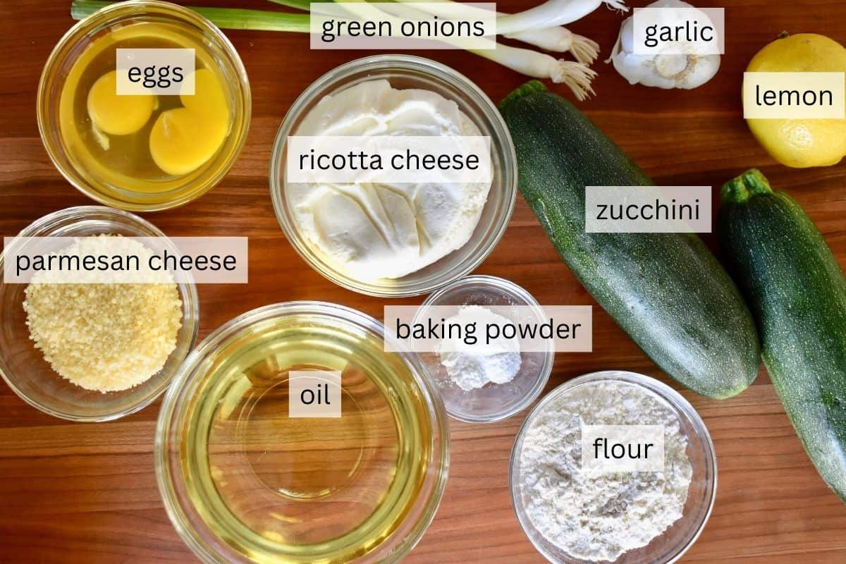 Ingredients needed for recipe including flour, eggs, Parmesan cheese, lemon, baking powder, and oil. 