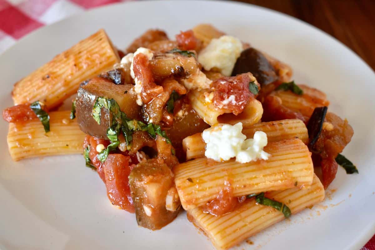 Pasta alla Norma on a plate with ricotta salata on top. 