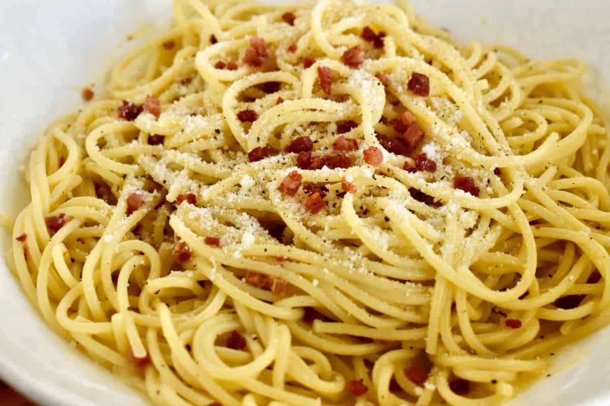Carbonara with Pancetta in a white bowl. 