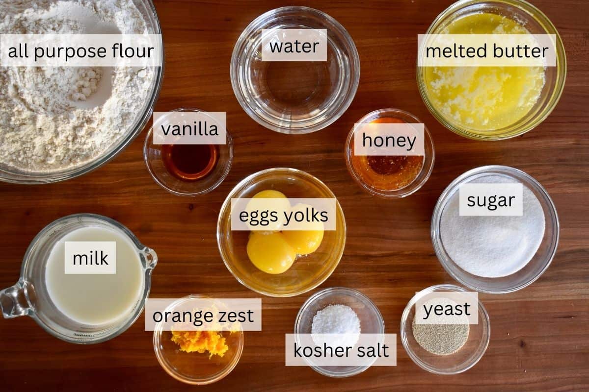 Ingredients needed for bread including honey, orange zest, egg yolks, melted butter, and flour. 