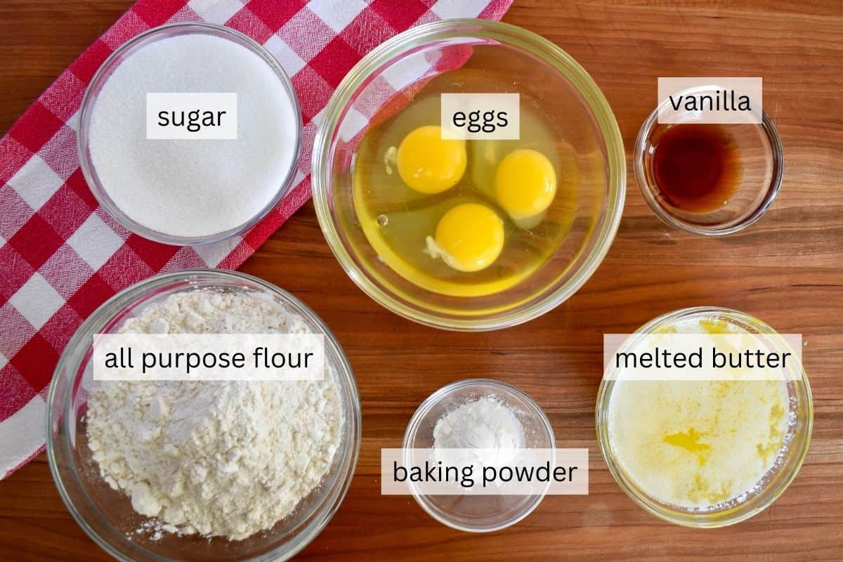 Ingredients for recipe are eggs, sugar, vanilla, flour, baking powder, and melted butter. 