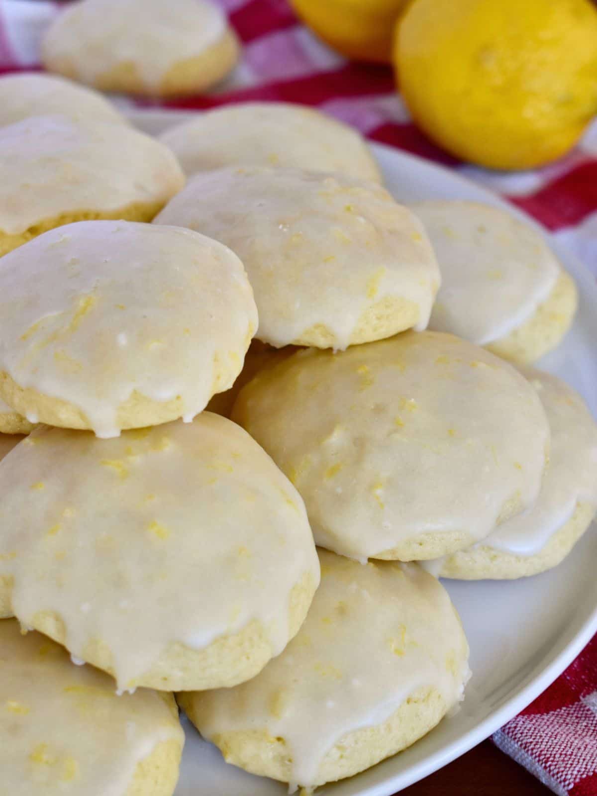 Italian Lemon Drop Cookies stacked on a white plate. 