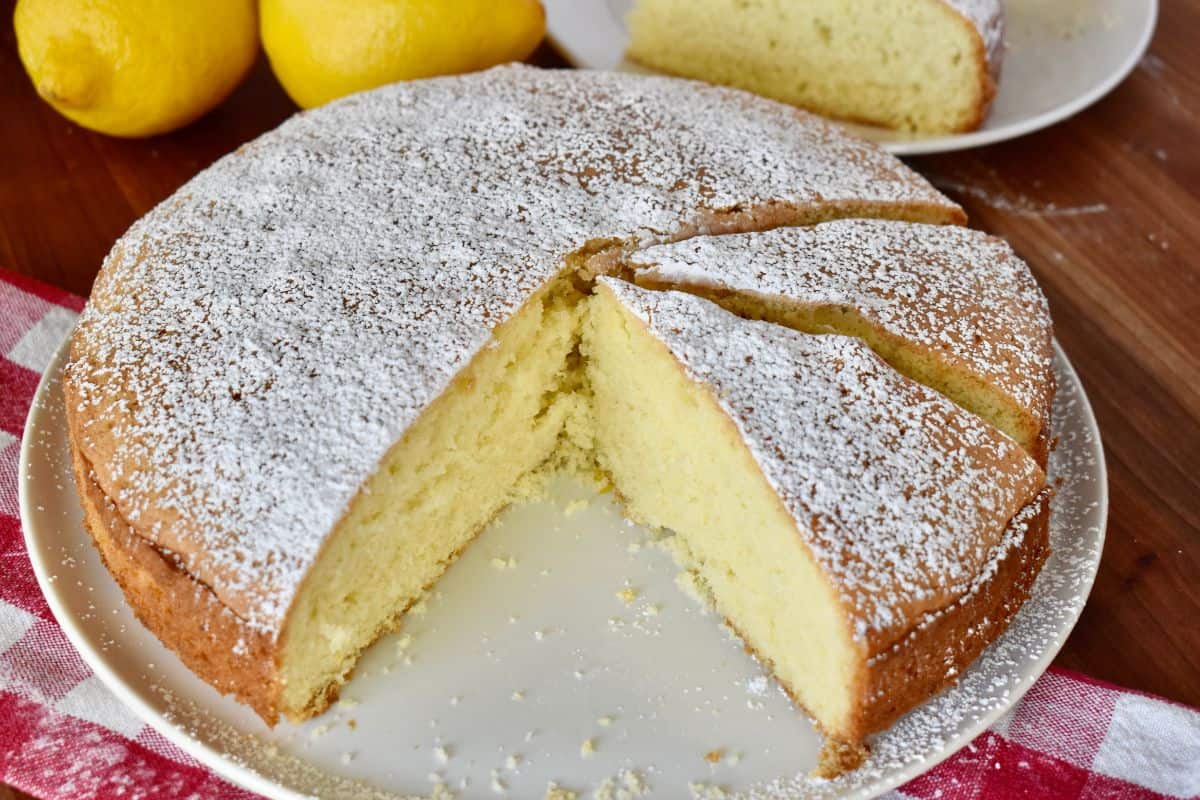 Torta Paradiso cut into slices on a white plate. 