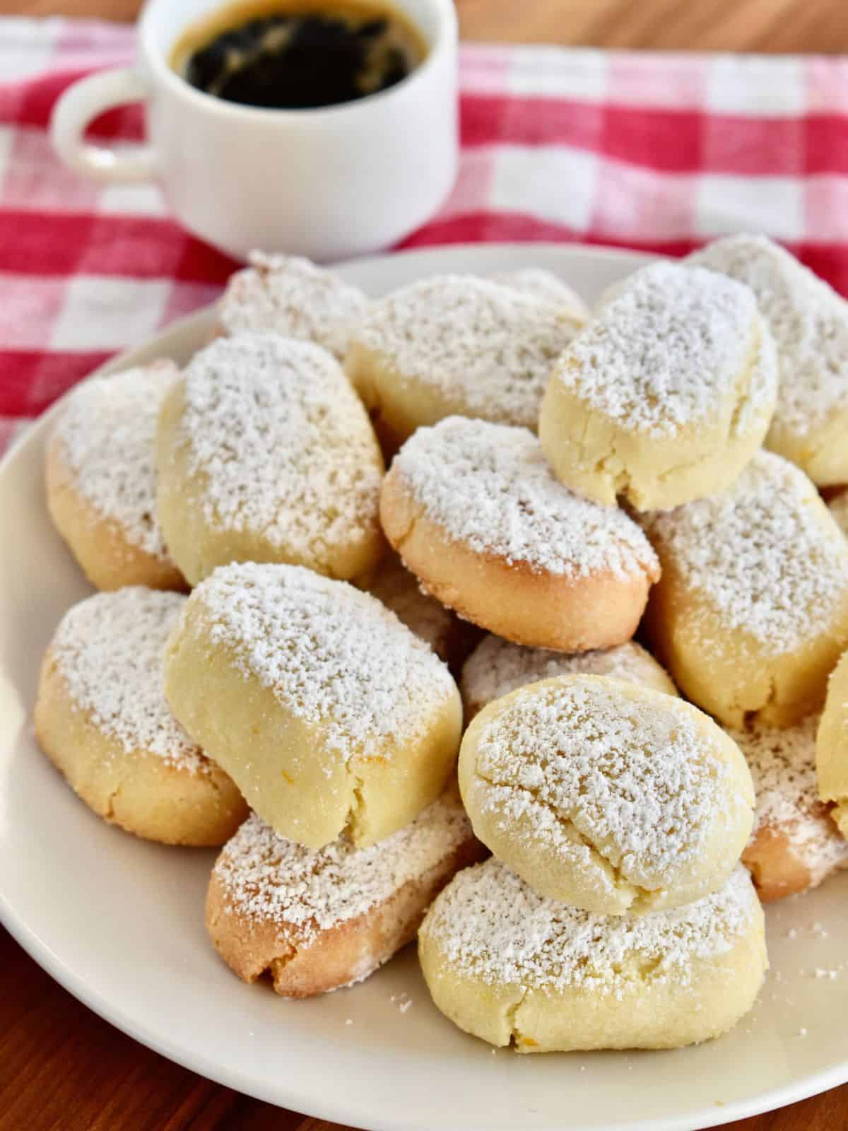 Stack of Ricciarelli cookies on a white plate. 