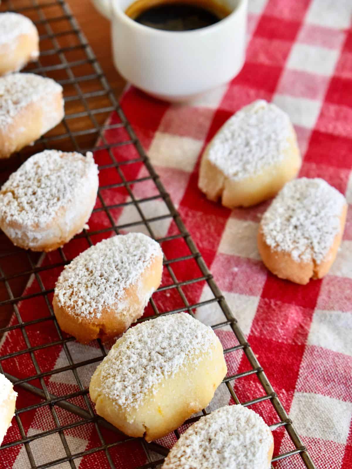 Ricciarelli Cookies on a wire rack with a checkered napkin underneath. 