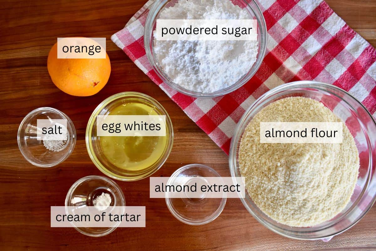 Ingredients for recipe including almond flour, egg whites, orange zest, powdered sugar, and almond extract. 