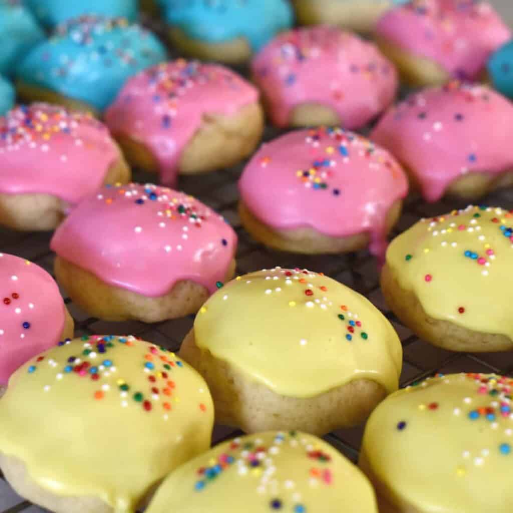 Classic Italian Easter cookies frosted in yellow, pink, and blue colors