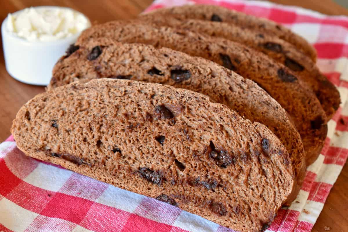 Sliced Pane al Cioccolata with a container of mascarpone cheese next to it. 