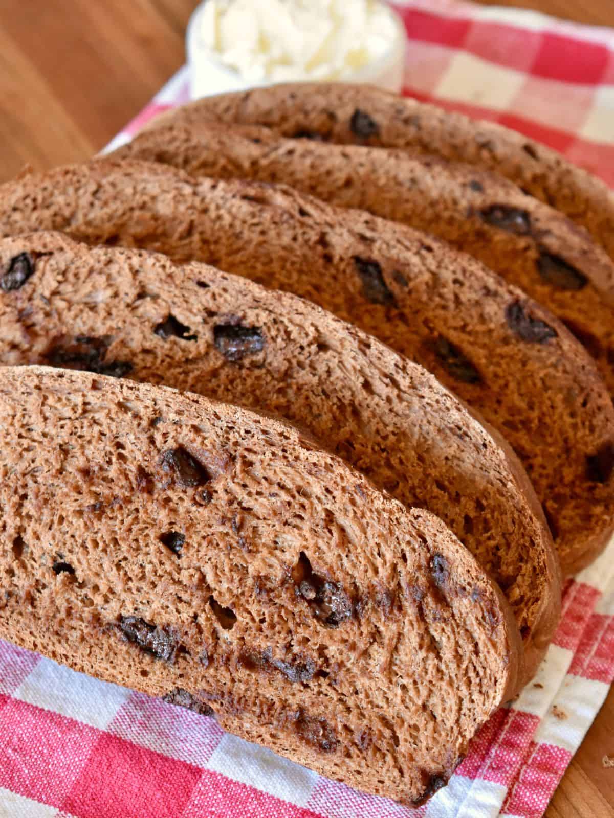 Italian Chocolate Bread known as Pane al Cioccolata sliced and served on a checkered cloth. 