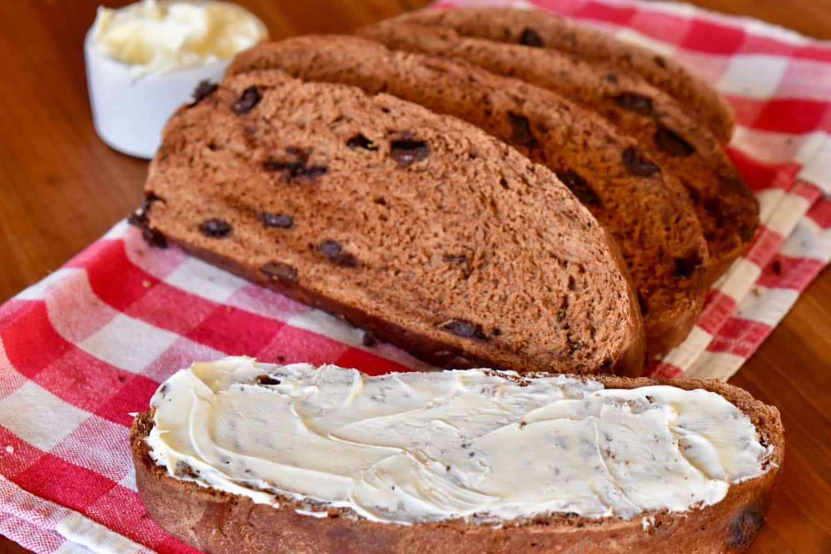 Pan al Cioccolata sliced on a checkered napkin with mascarpone spread on top. 