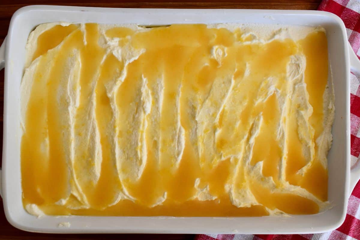 Overhead photo of completed recipe in a white serving dish with lemon curd drizzled on top.