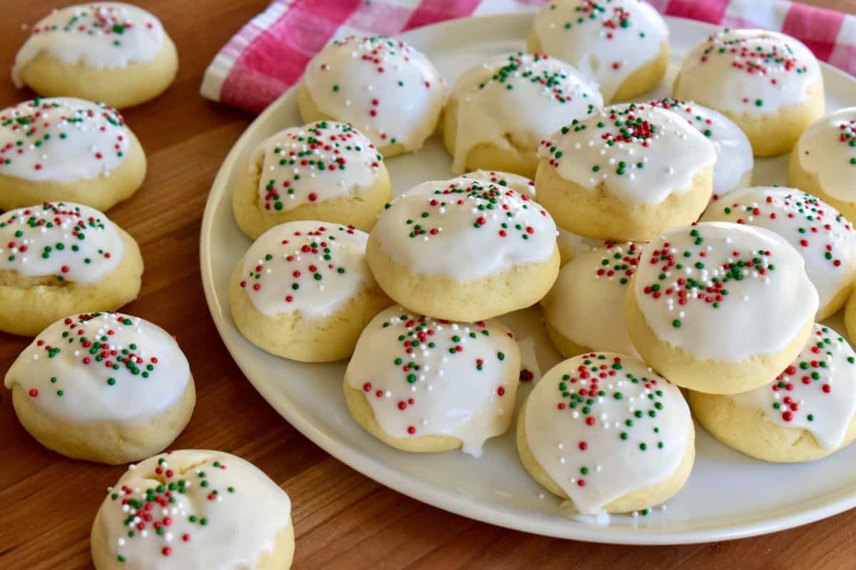 Italian Christmas cookies with red and green sprinkles on a white plate. 