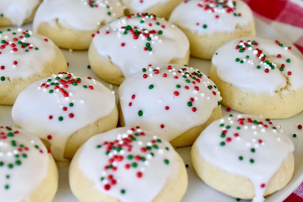 Italian Christmas Cookies frosted on a white plate. 