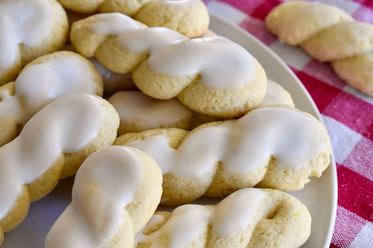 Italian Twist Cookies with lemon glaze on a white plate. 