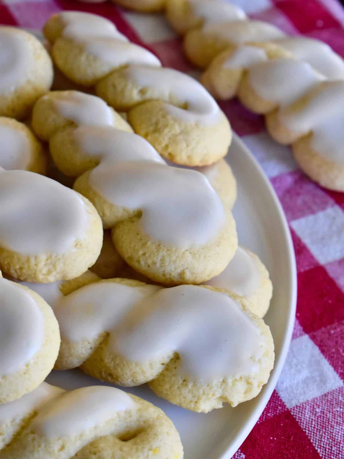 Italian Twist Cookies with lemon glaze on a white plate. 