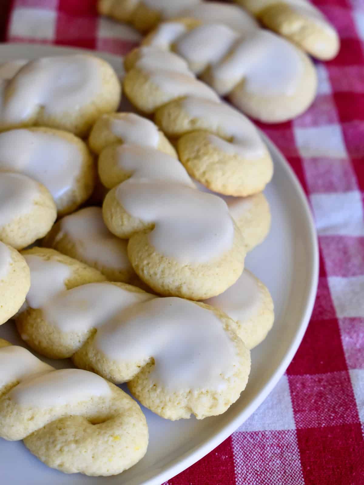 Italian Twist Cookies on a white plate with a checkered napkin. 