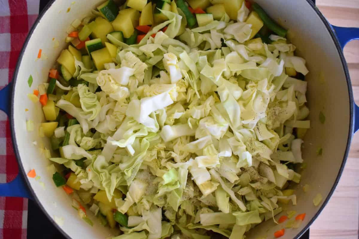 Cabbage, green beans, and potatoes added to the pot. 