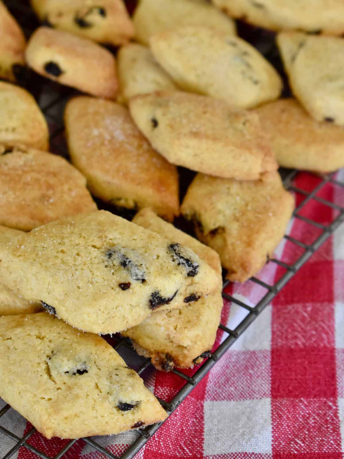 Zaleti cookies on a wire cooling rack with a red checkered napkin underneath. 