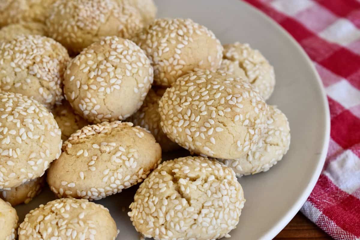 Italian sesame cookies on a white plate. 