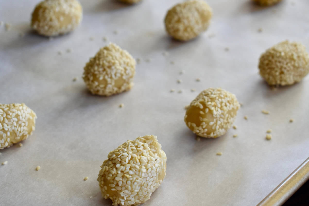 Italian Sesame Seed Cookies on a lined baking sheet. 