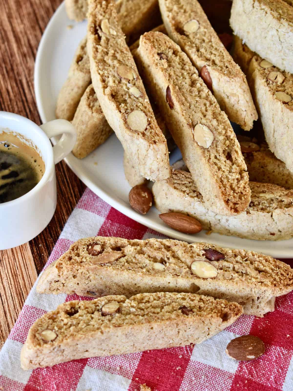 Whole Wheat Biscotti on a checkered napkin with a cup of coffee. 