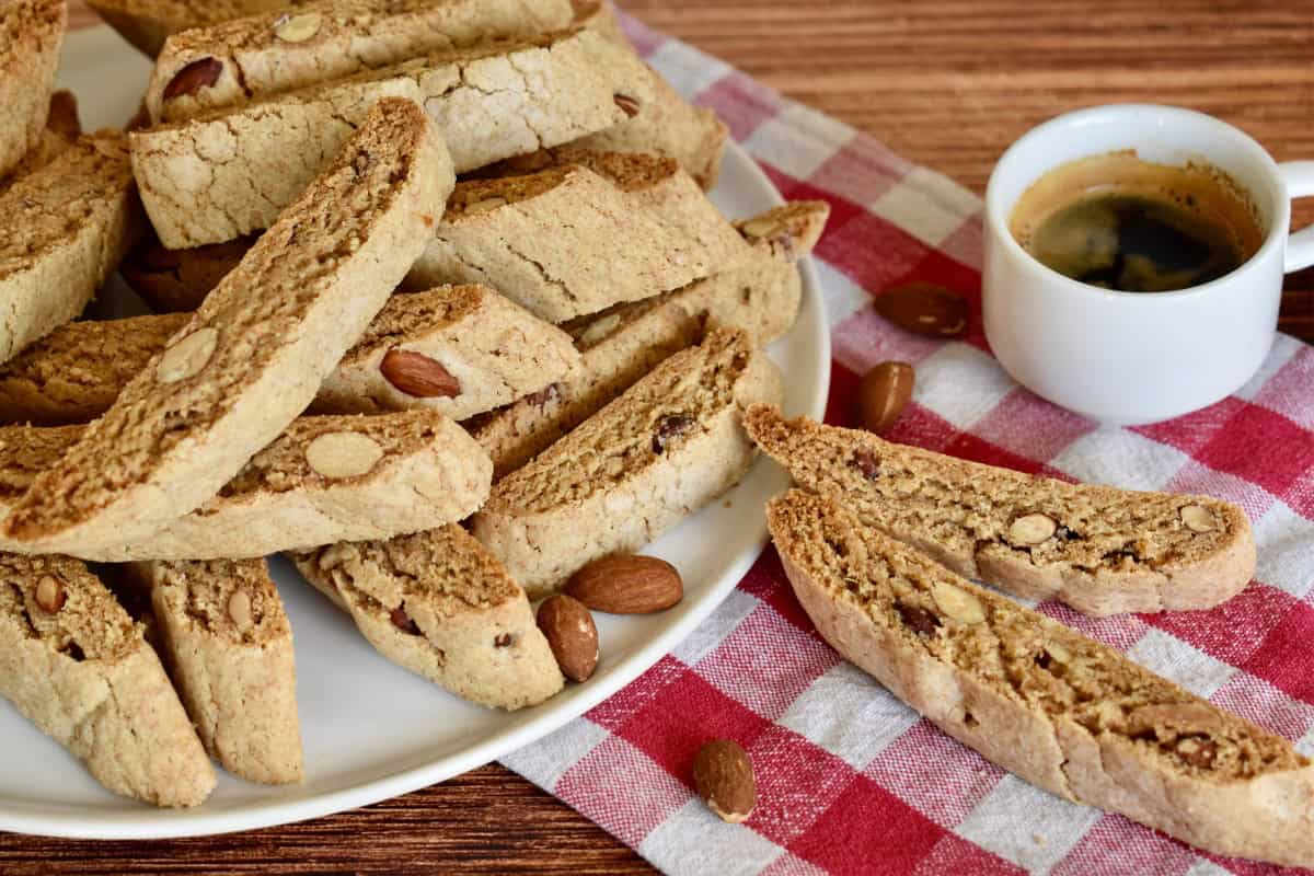 Whole Wheat Biscotti on a plate with a cup of coffee. 