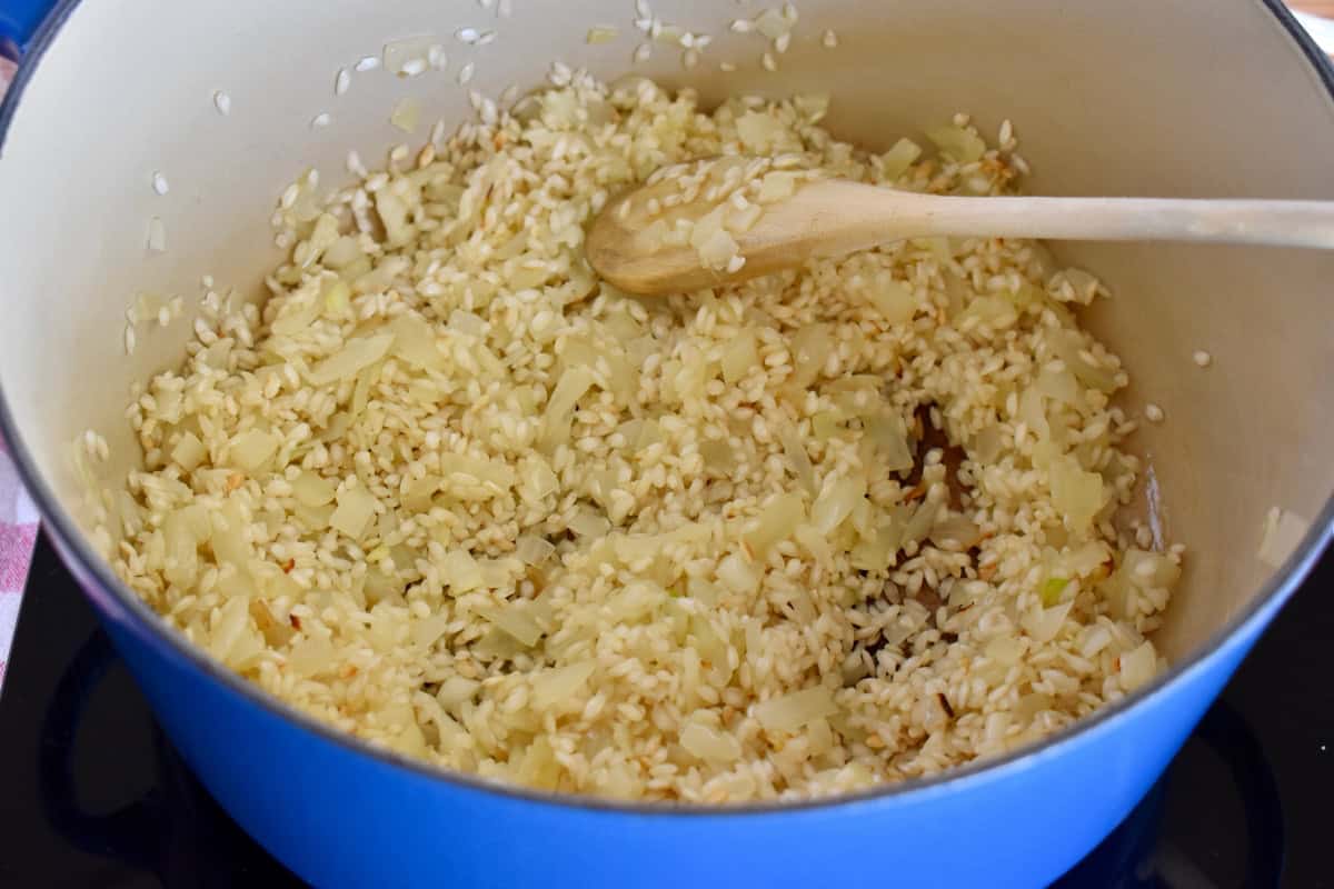 Onions, butter, and olive oil cooking in a large dutch oven pot. 
