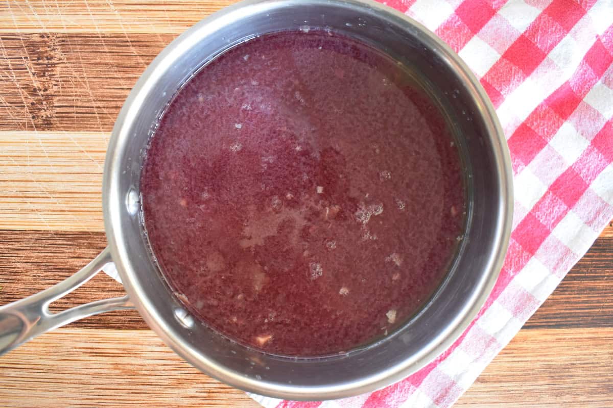 Red wine and broth in a small sauce pan. 