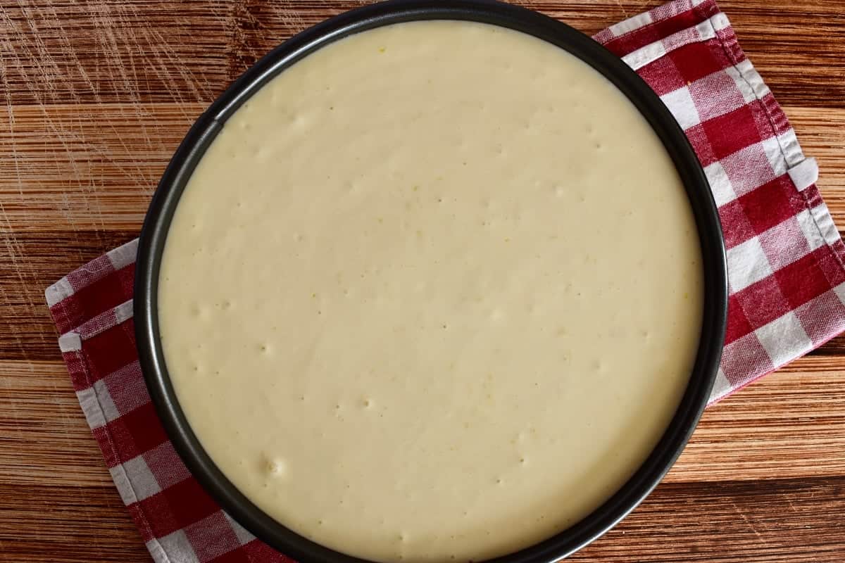 Ricotta cheesecake mixture poured into the springform baking pan. 