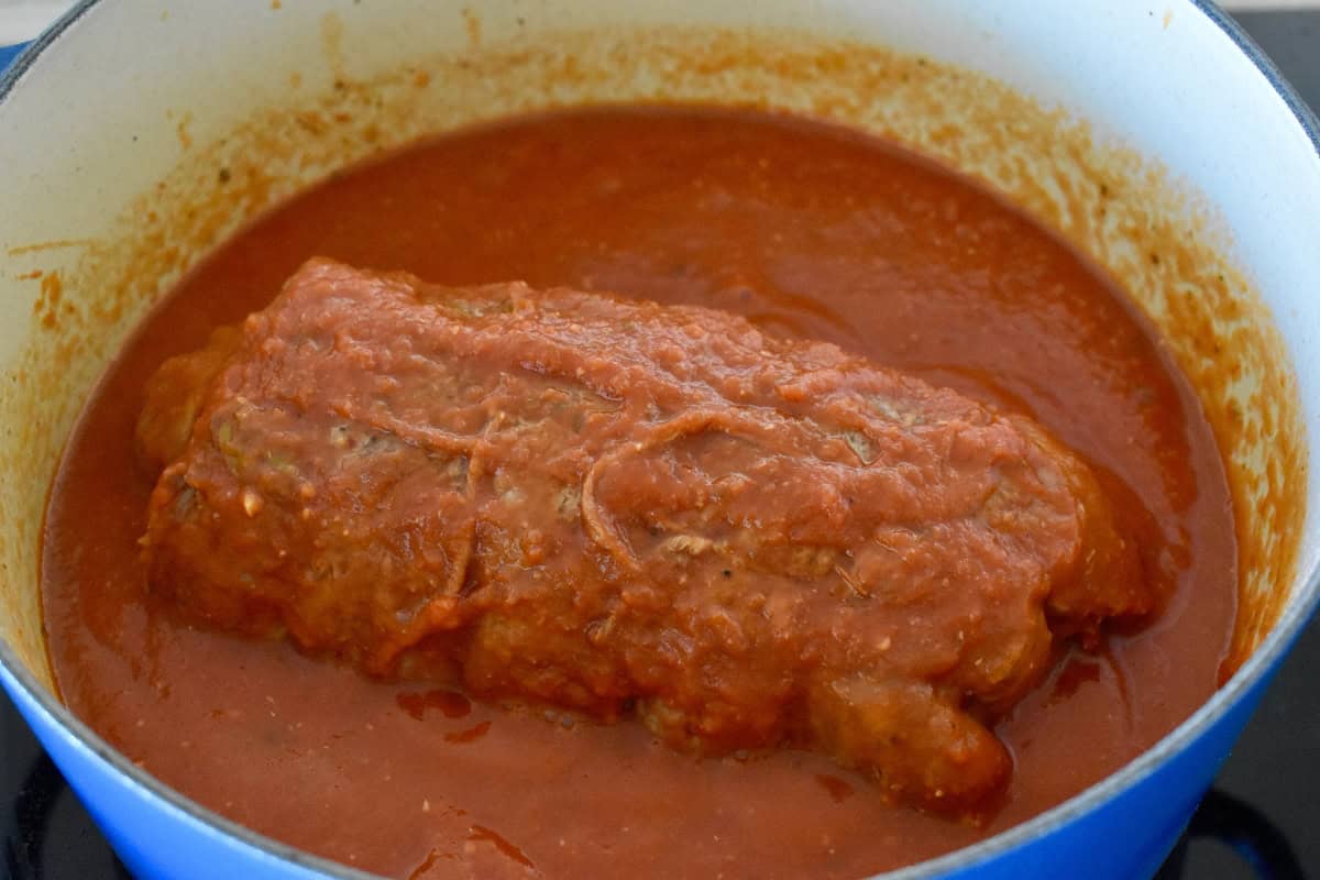 Marinara sauce poured over the meat roll in a dutch oven. 
