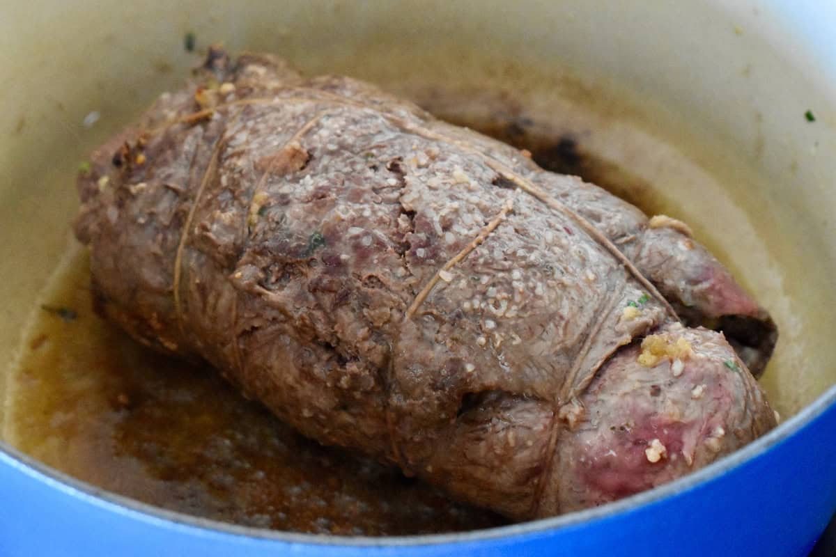 Braciole meat rolled browned in a large dutch oven. 