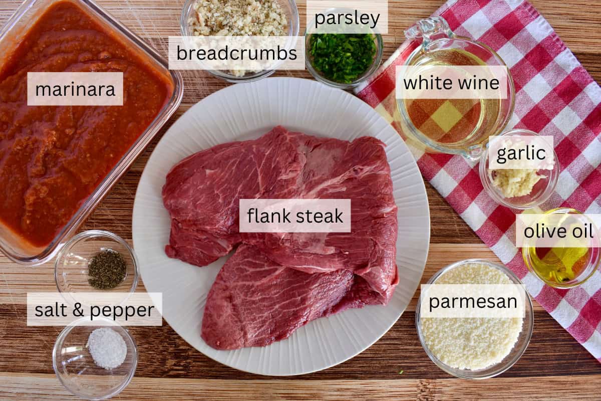 Ingredients for recipe including flank steak, bread crumbs, and parmesan cheese. 