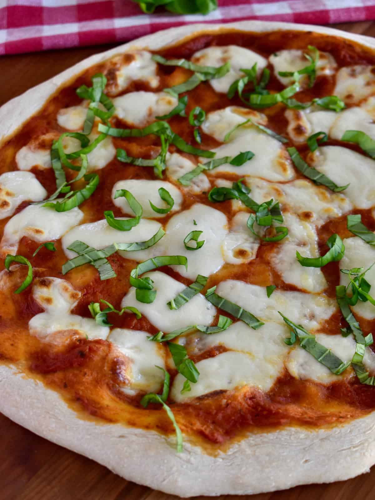 Overnight pizza dough used to make Italian Margherita pizza with basil on top. 