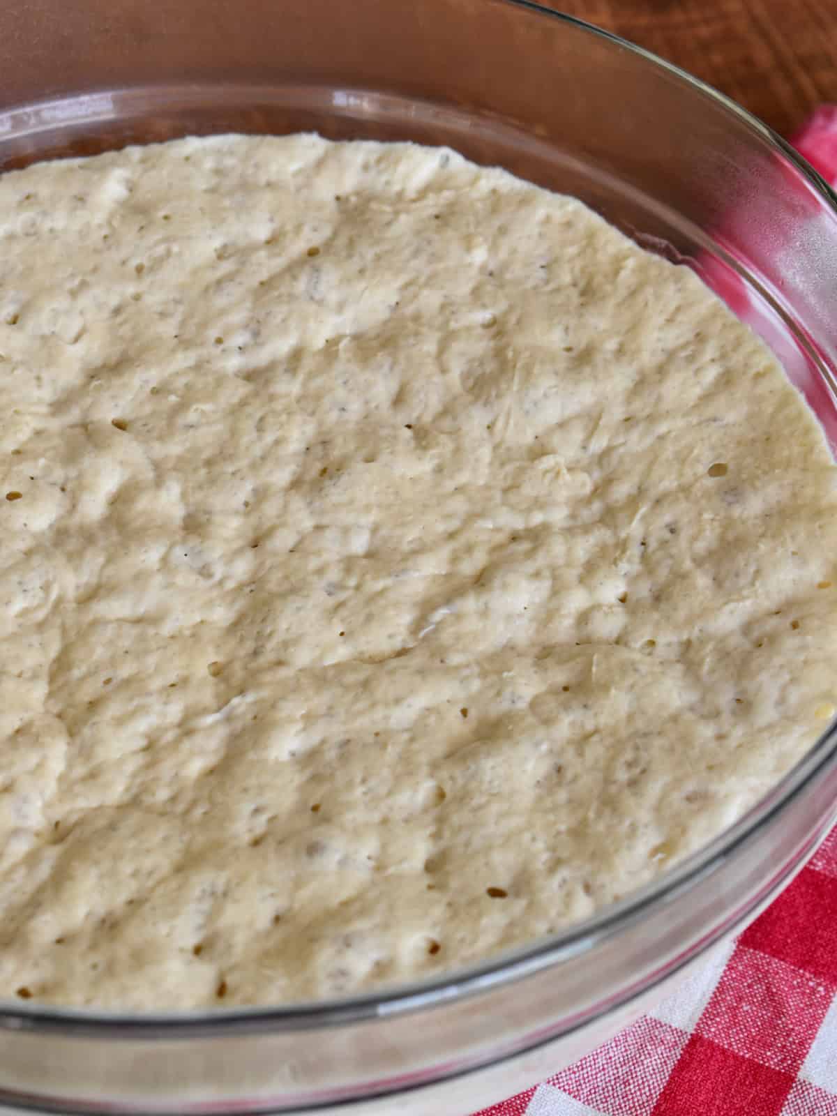 Overnight Pizza Dough in a glass bowl.