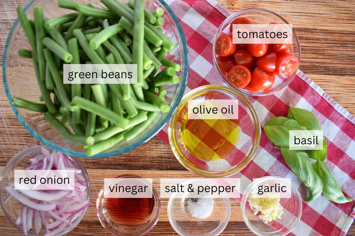 Ingredients for recipe including tomatoes, onions, olive oil, vinegar, and garlic. 