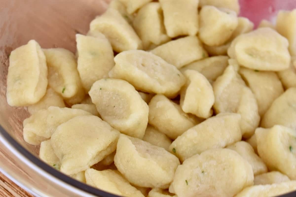Cooked ricotta gnocchi in a glass bowl. 