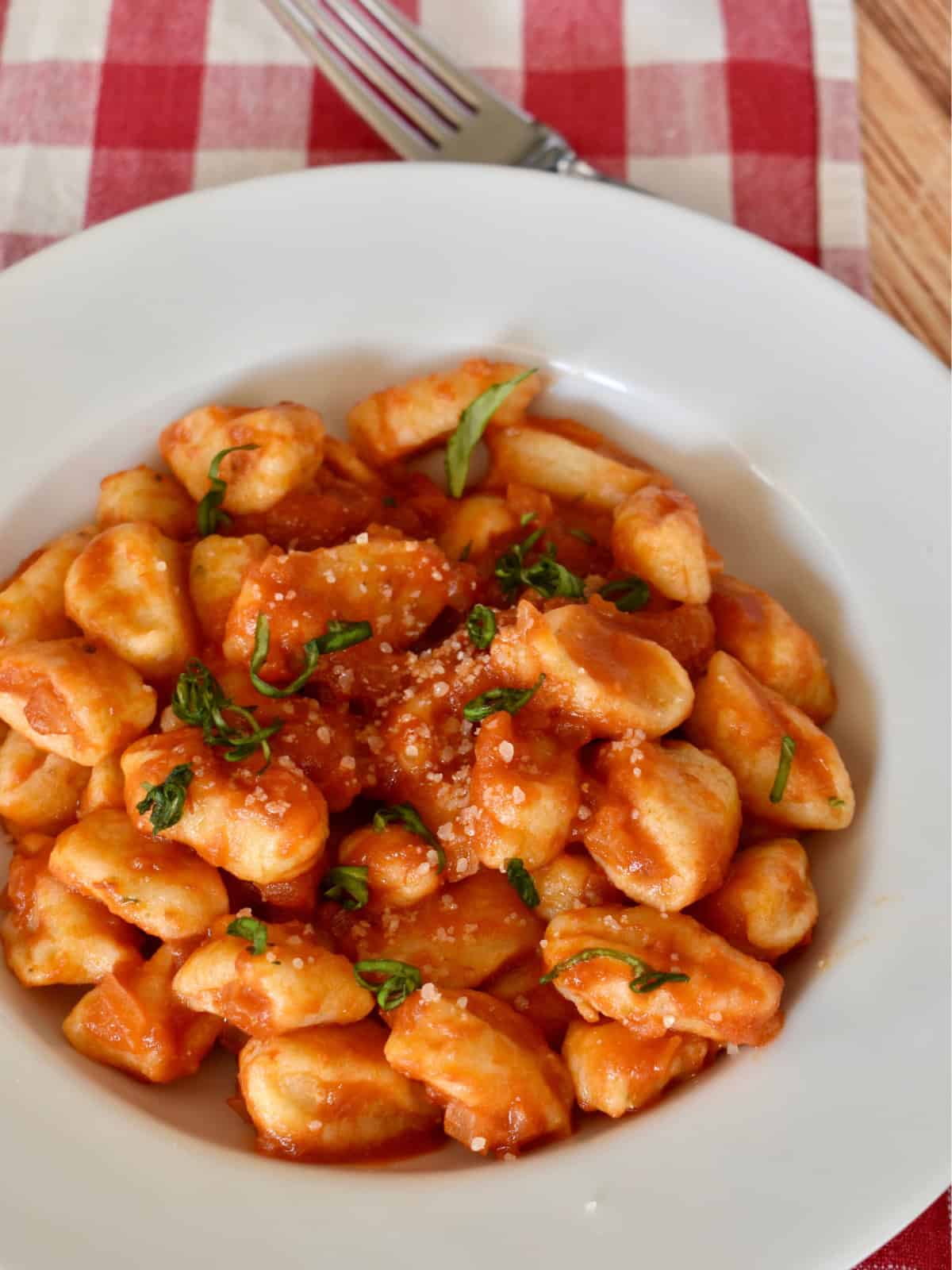 Ricotta Gnocchi with butter tomato sauce in a white bowl. 