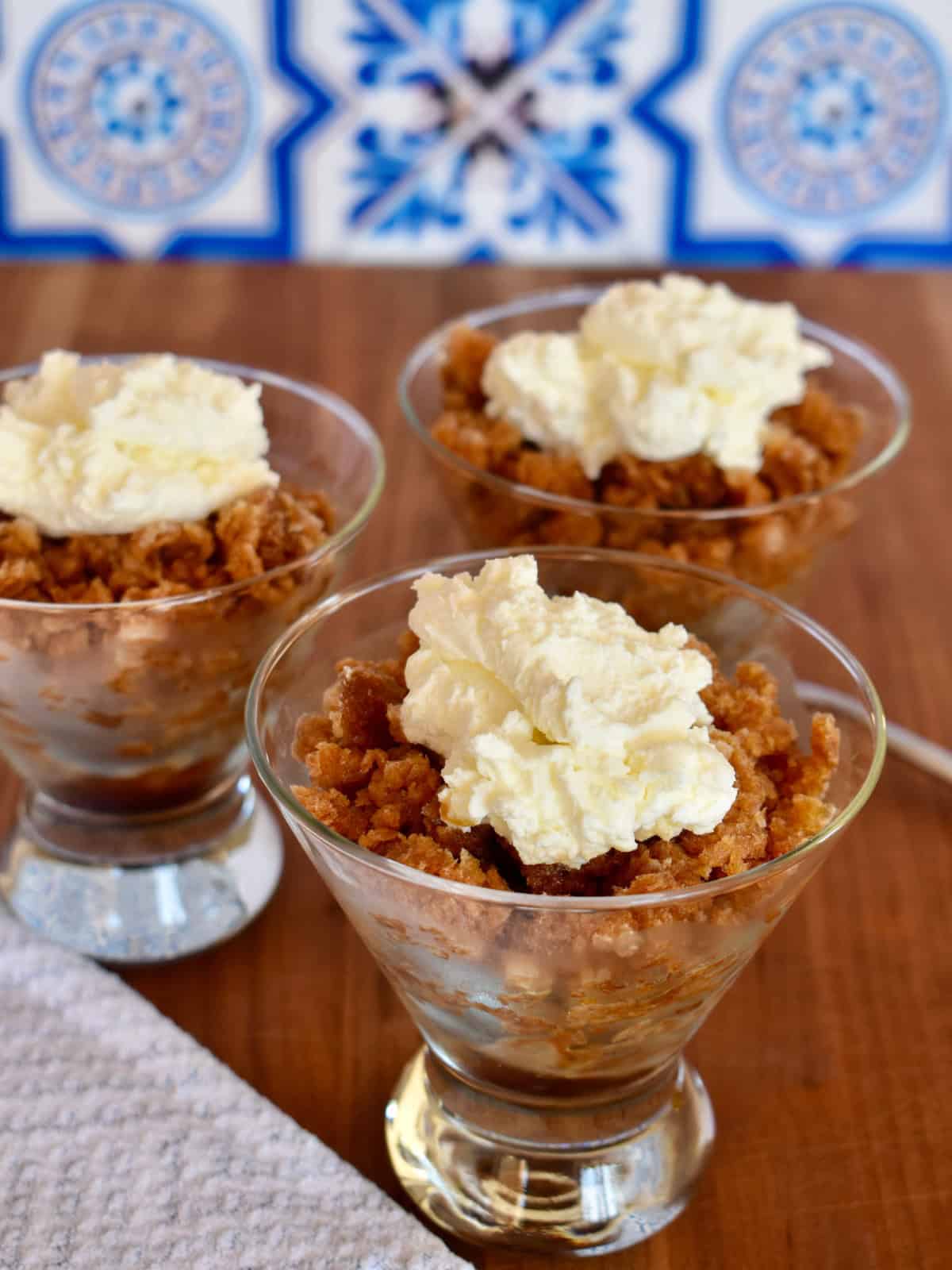 Espresso Granita with whipped cream in a glass cup on a countertop. 