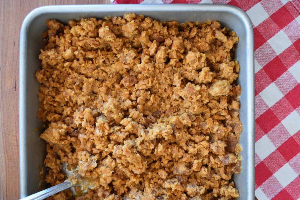 Espresso granita scraped into light flaky pieces in a square baking pan. 